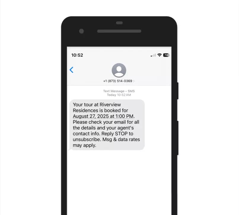 Automated tour confirmation text message showing booking details and property information